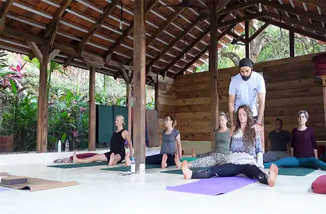 Sukhvinder Singh Chaitanya assisting a student during Yin Yoga TTC in Goa