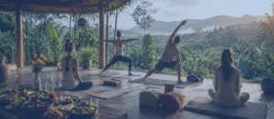 What happens at a yoga retreat: participants practicing yoga, meditation, healthy eating, and relaxation during a residential yoga retreat experience in nature