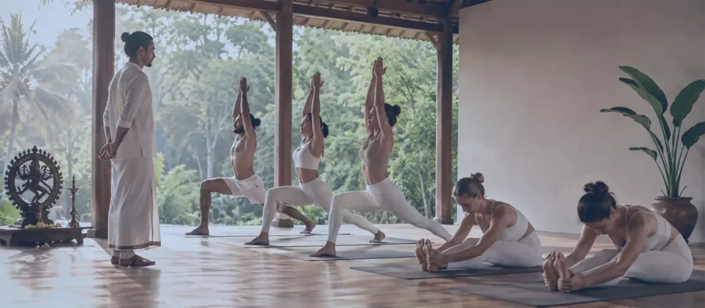 What Is Ashtanga Yoga practice with a teacher guiding students in an open-air yoga shala