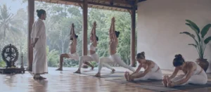What Is Ashtanga Yoga practice with a teacher guiding students in an open-air yoga shala